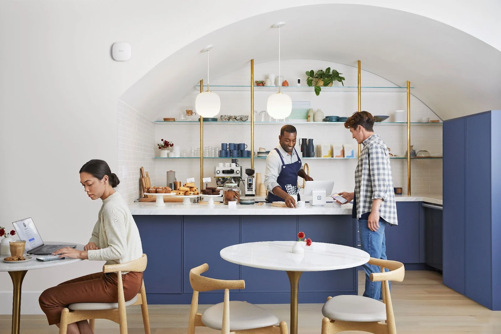 Three individuals in a cafe