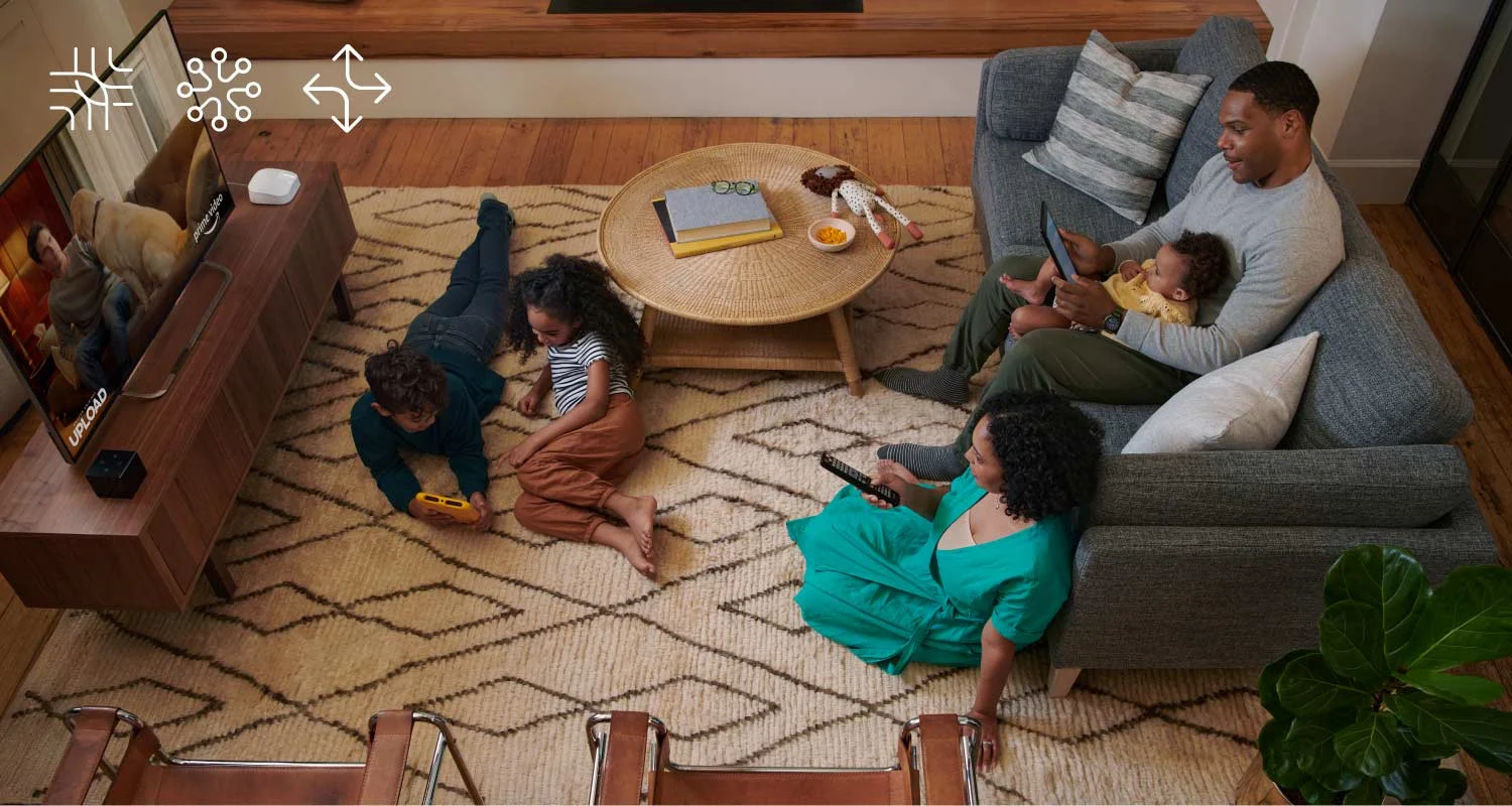 a family sitting in a living room all on different devices